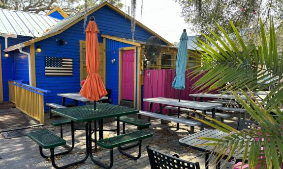 The back porch has additional seating with umbrellas offering shade