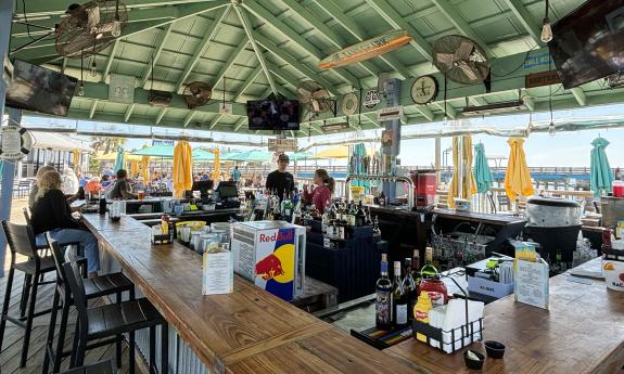 The outside bar with TVs surrounding the section