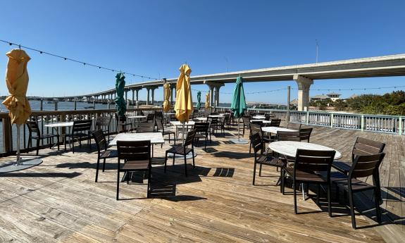 Outdoor seating overlooking the Vilano Bridge and water