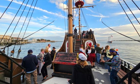 Passengers and crew aboard the Black Raven on a Tropical Sunset Cruise