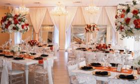 A grandiose wedding reception set up with floral centerpieces in the ballroom
