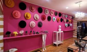 An array of hats hanging along the wall inside the shop