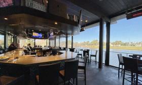 The back patio has a bar and extra seating overlooking the lake