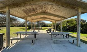 A spacious picnic pavilion is set up on the property