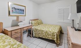 Just Beachy's guest room has one twin and one double bed, a large flat-screen televison and a desk