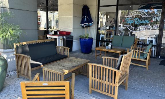 Couches and chairs fill the outdoor patio space