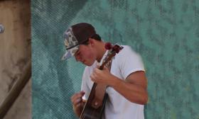 Musician Davis Cook playing onstage with guitar