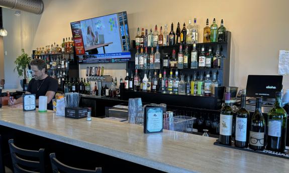 The open bar with a TV set up behind the counter