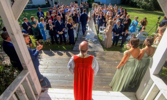 A camera is set up in the gazebo of a wedding ceremony