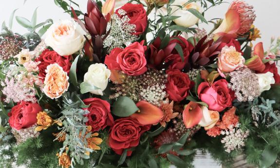 A floral arrangement with different colored roses