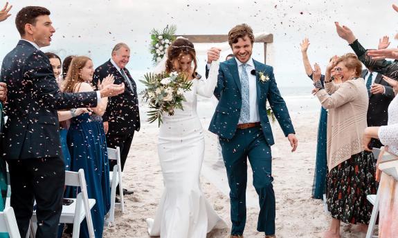 A newlywed couple walking the aisle after the ceremony