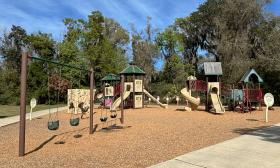 The playscape has swings, slides, and games