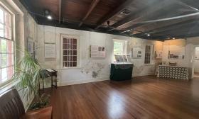 The second floor of the Tovar House at the Oldest House Museum Complex with the Winter Colony exhibit panels displayed.