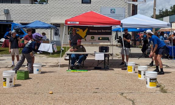 Contestants doing the potato toss during the Great Mow Down Lawnmower Race