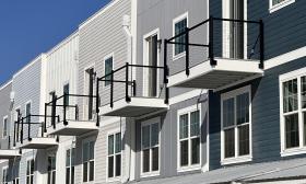 A row of three-story condos at Cortez on the Water are painted various shades of gray