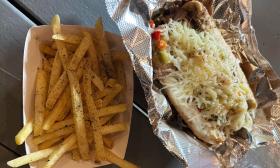 An Italian beef sandwich and a side of fries