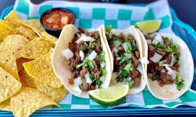 Street style tacos with a side of chips and salsa