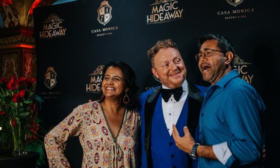 A couple pose with Master Magician Bill Abbott at the Casa Monica Resort and Spa