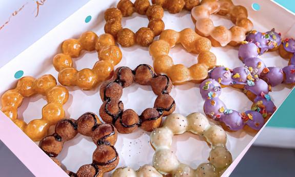 A box of different flavored mochi donuts