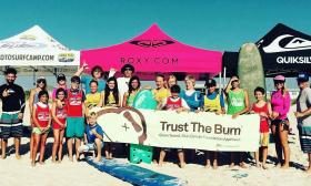 Surfers arrrayed on the beach during the Trust the Burn event