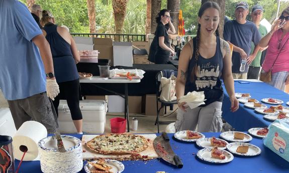 Various types of pizza samples are distributed