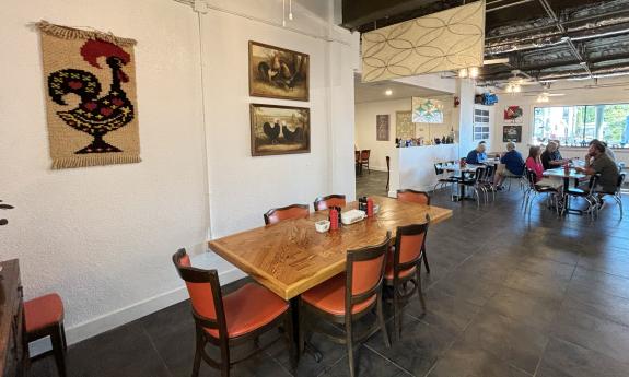 Rustic decor line the walls surrounding the dining tables