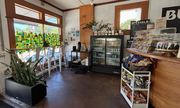 There is a fridge, snacks, and window seating near the door's entrance