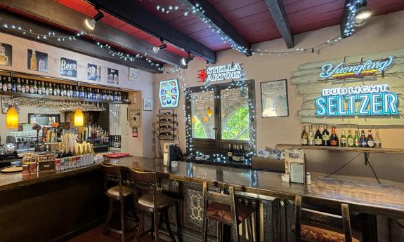 The bar area and stools line the the back wall