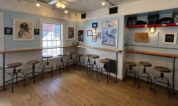 Stools line the walls and windows for indoor dining