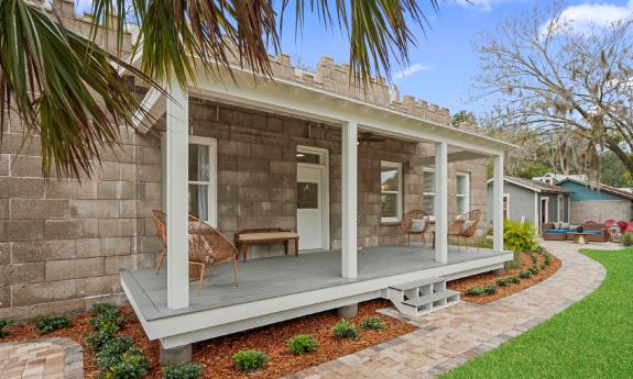 The back deck of a vacation rental that has castle elements in the design