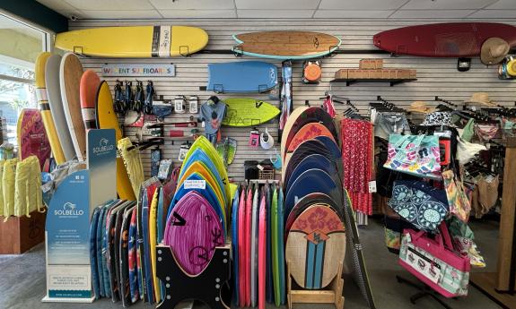 An assortment of boards for sell and rent inside