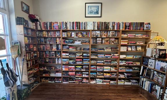 A large bookcase selection near the door's entrance