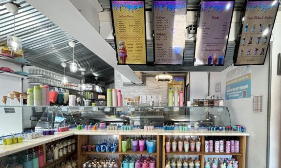 Screened menus hang above the counter area