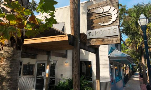 Timoti's in Nocatee has a wood and metal sign with a large shrimp above their name