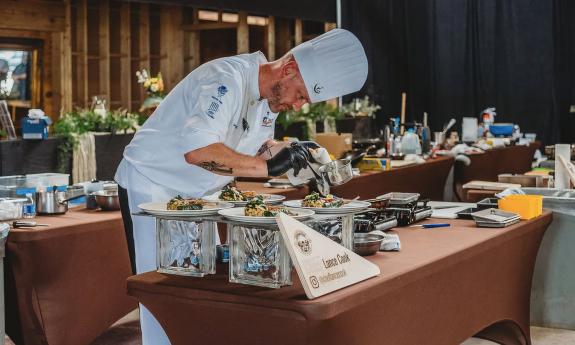 Chef Lance Cook preparing food at Hastings' inaugural Cabbage, Potato, and Bacon Festival