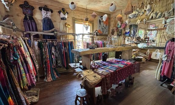 Apparel pieces arranged on racks and tables in-store