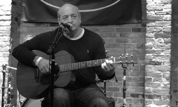 Steven Dale Jones singing with his acoustic guitar