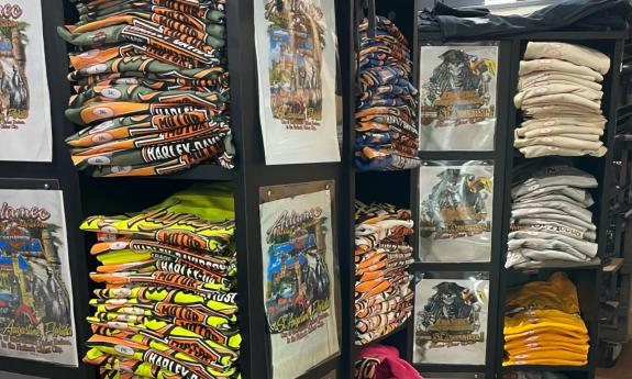 Harley-Davidson shirts with colorful art on display