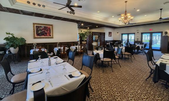 The dining room at La Cocina at Cellar Upstairs, with white tablecloths and well-spaced seating