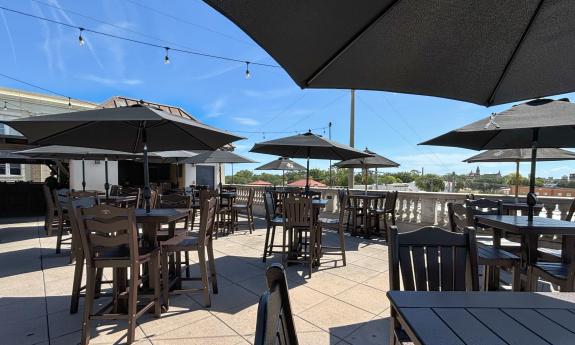A view of the roof deck at Cellar Upstaris on a sunny day with a blue sky