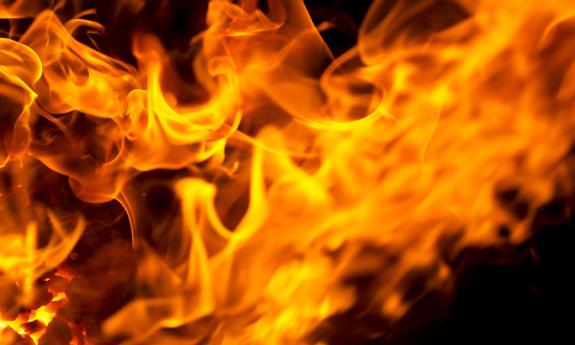 Flames buring in organe and red against a dark sky