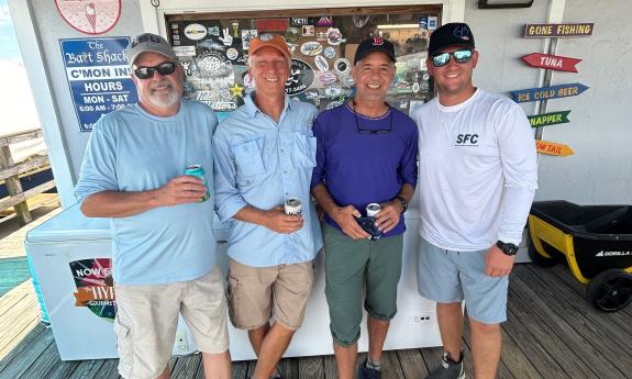 A group of men in Vilano posing for after their fishing charter tour