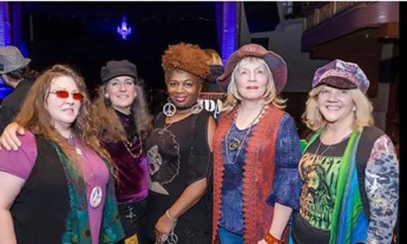 Five woman band, the Vintage Vixens standing together, smiling