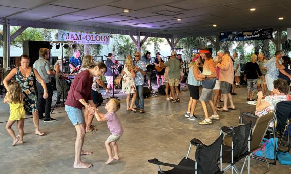 Music lovers dance in the pavilion's open area