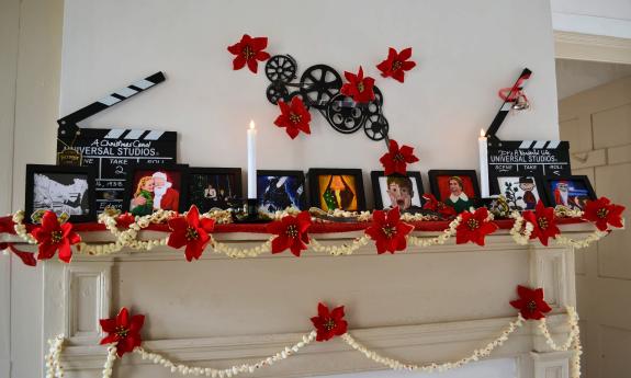 This bright mantel has a red, white, and black theme, highlighting famous Christmas films