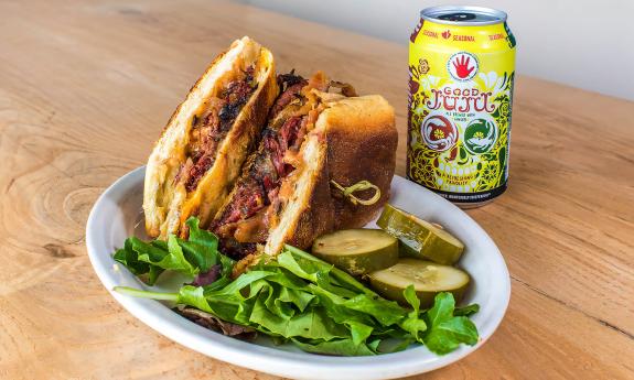 A sandwich with a side of pickles
