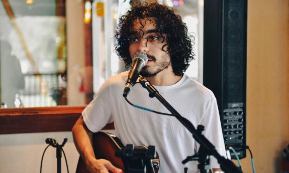 David Julia singing and playing his electric guitar