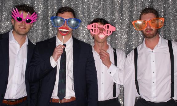 A group of men acting goofy in a photo booth
