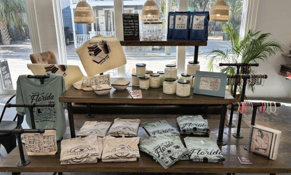 Tote bags, apparel, jewelry, and home decor on display