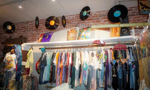 Racks of clothes and records hanging from the ceiling